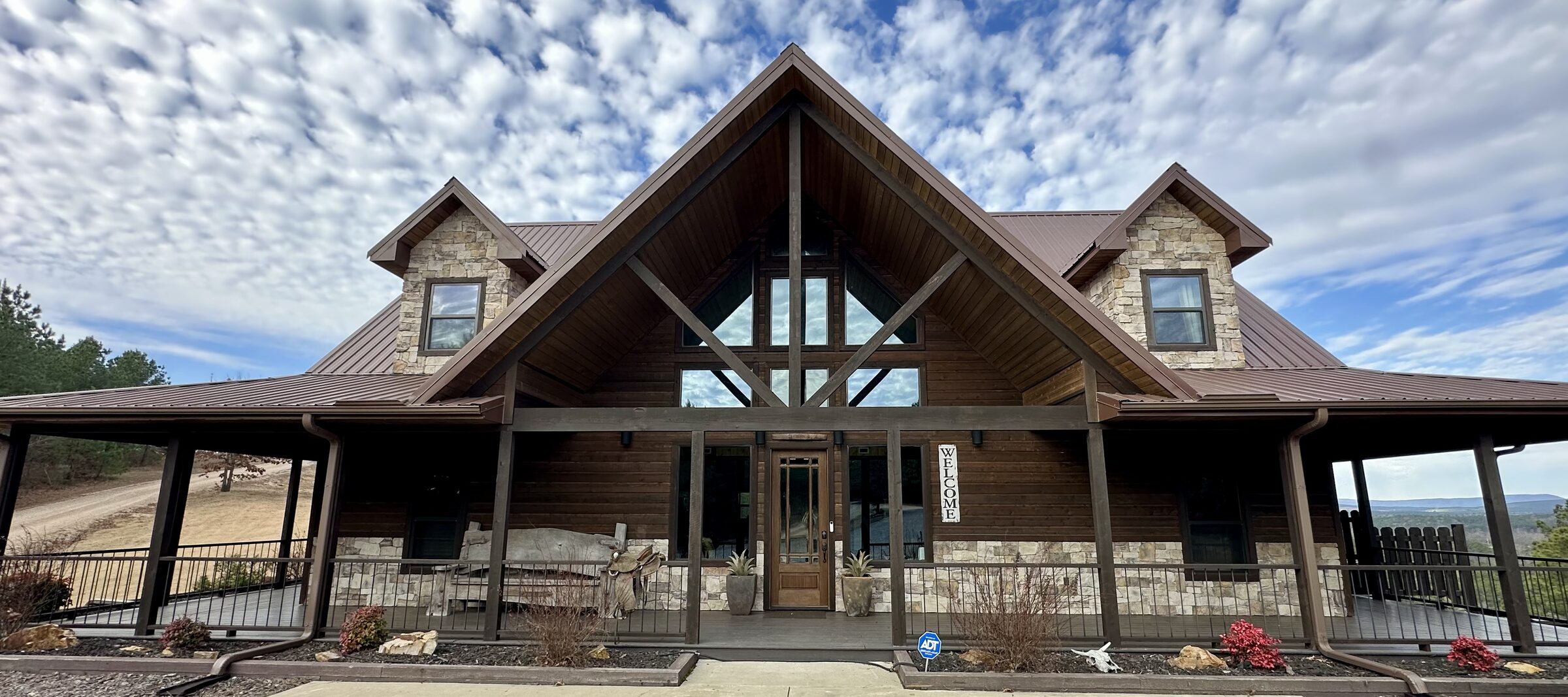 The timber-and-stone lodge under dramatic mountain skies