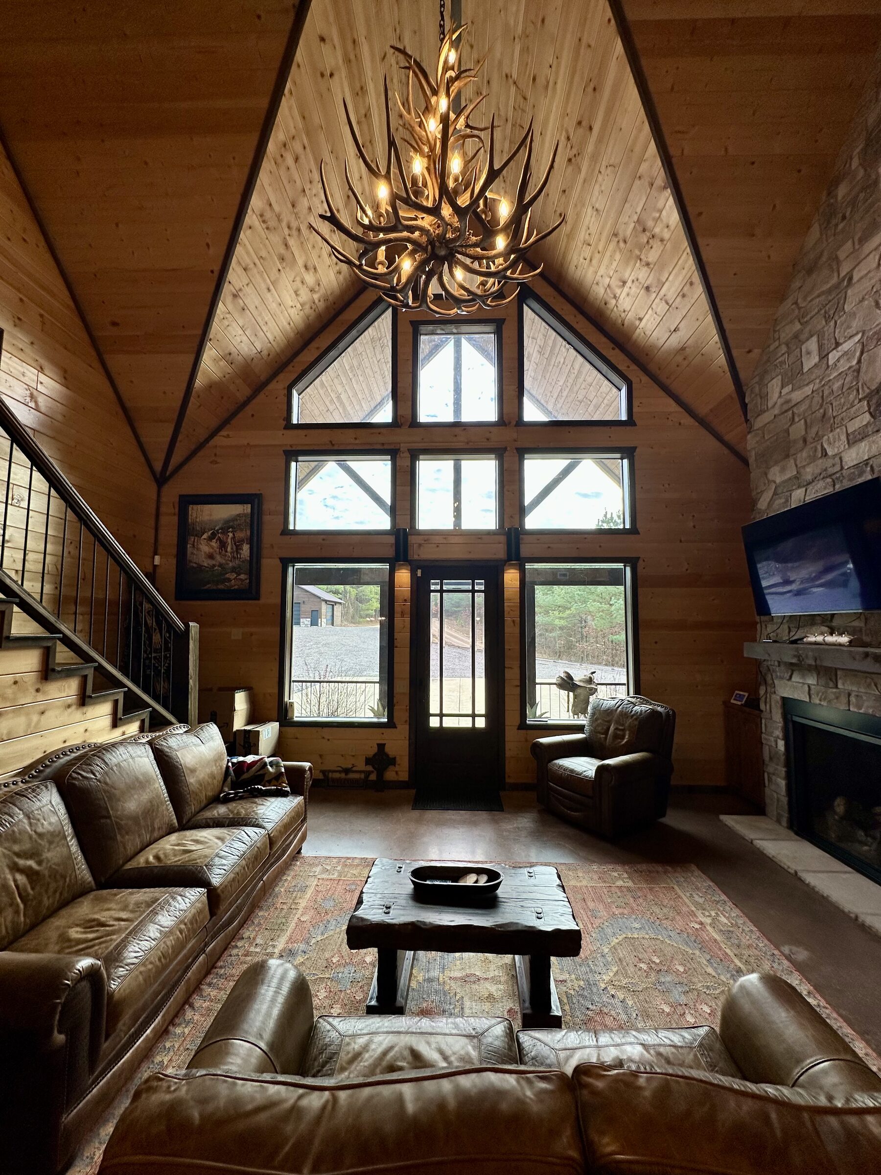 Great room under an antler chandelier