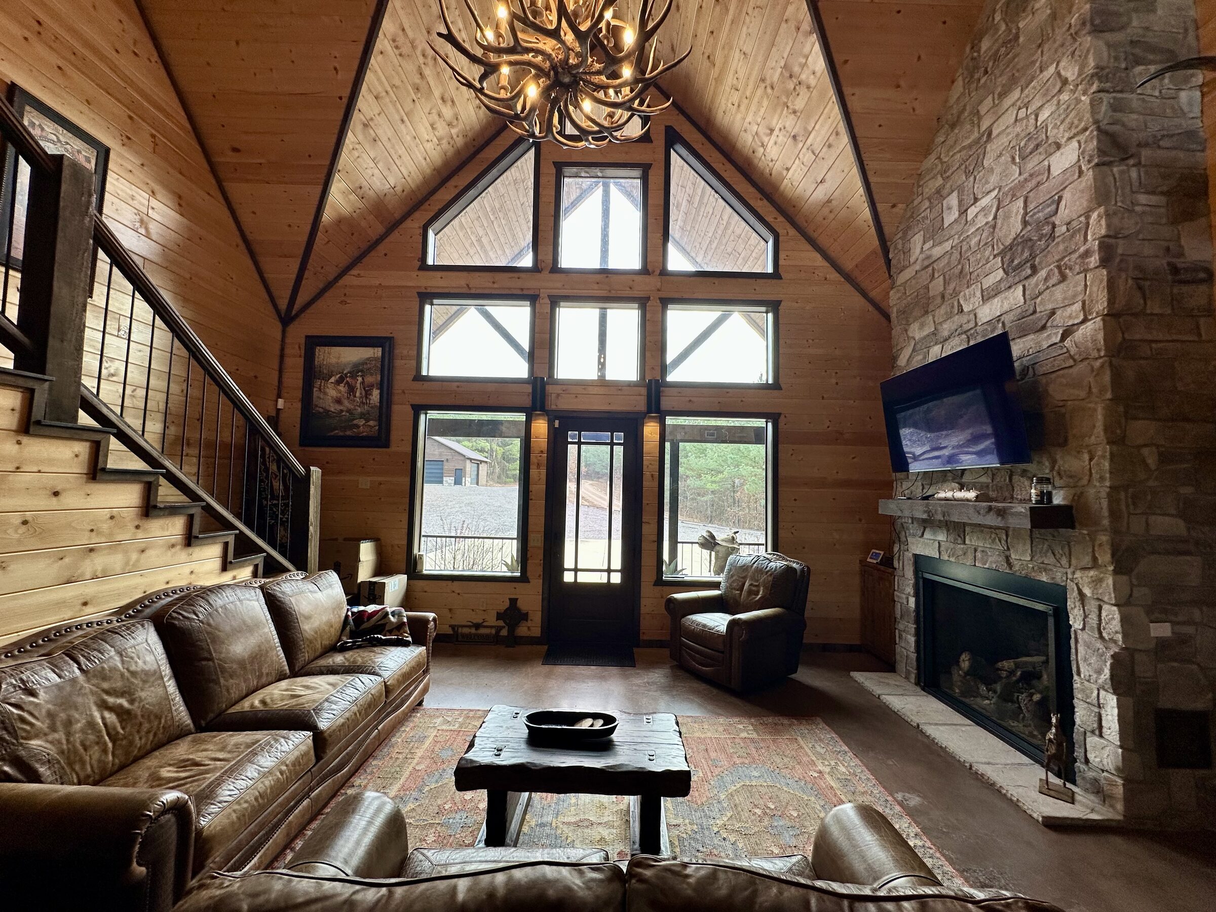 Great room with soaring stone fireplace and cathedral windows