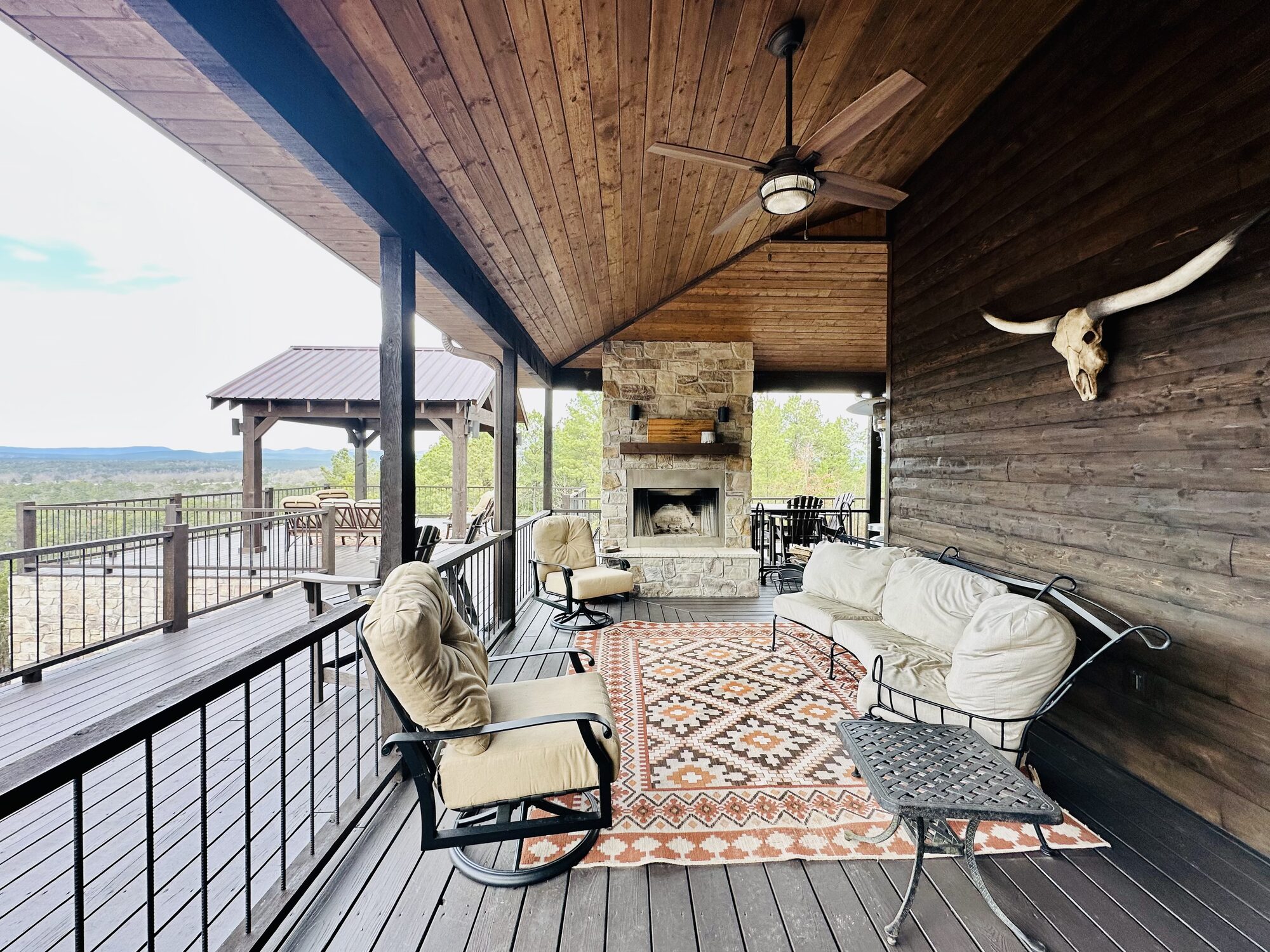 Covered porch lounge with stone fireplace