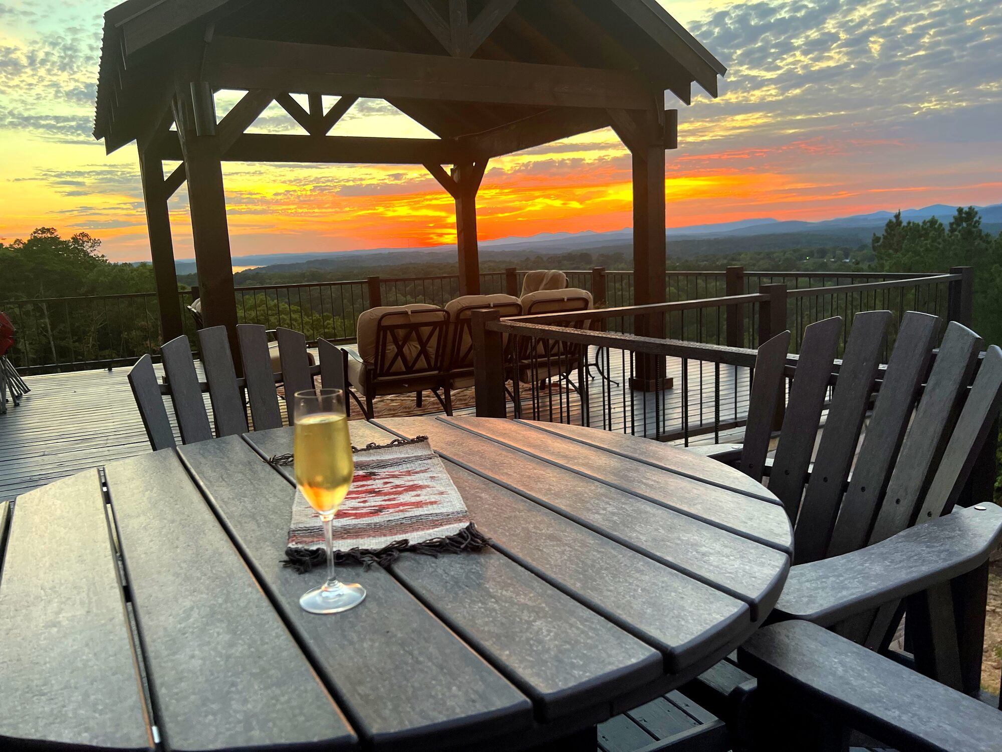 Golden-hour view from the covered pavilion over the Ouachita Mountains